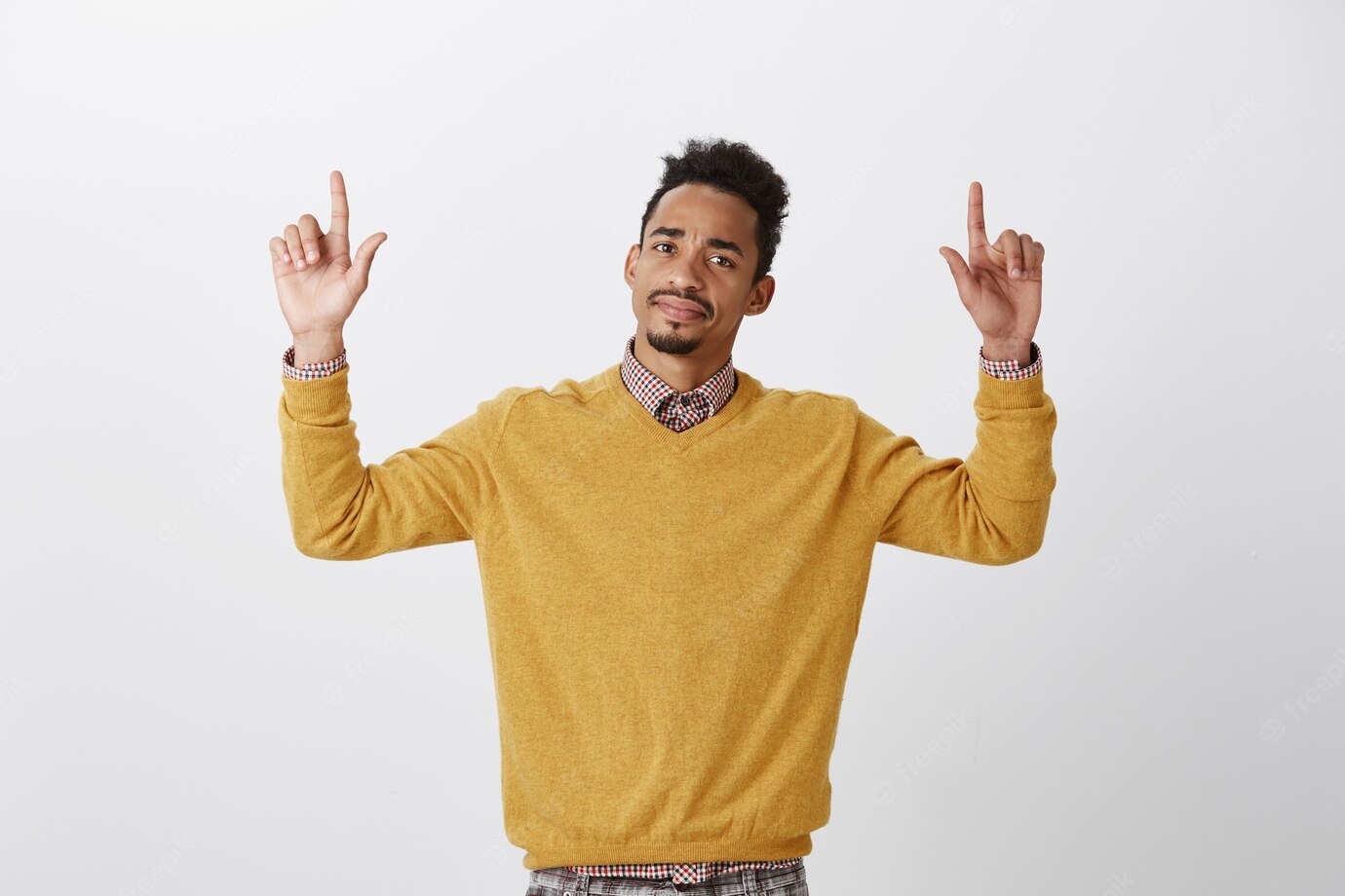 What Disappointment Portrait Displeased Doubtful American Guy With Afro Hairstyle Raising Hands Pointing Up With Index Fingers Expressing Disgust Doubt Standing 176420 25074