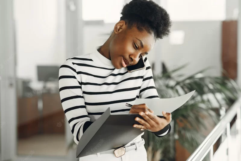 Woman with mobile phone. lady with documents. Free Photo