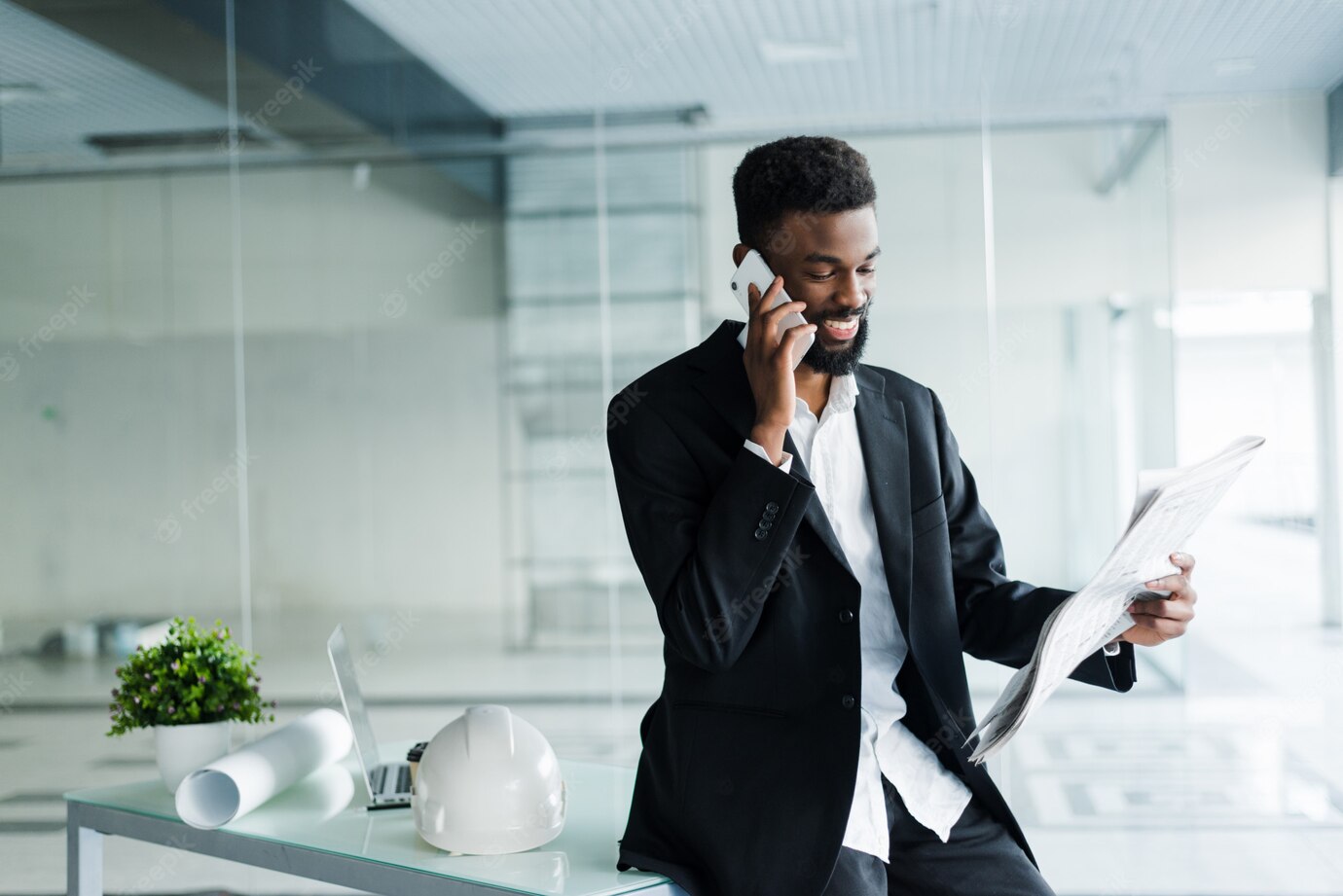 Young African American Businessman Reading Newspaper Talking Phone His Office 231208 761