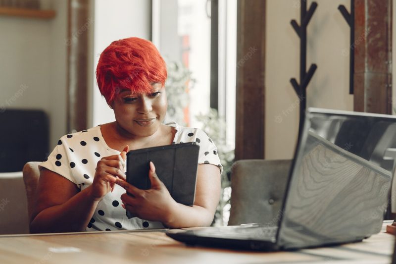 Young African American female working in an office. lady in a white blouse. Free Photo