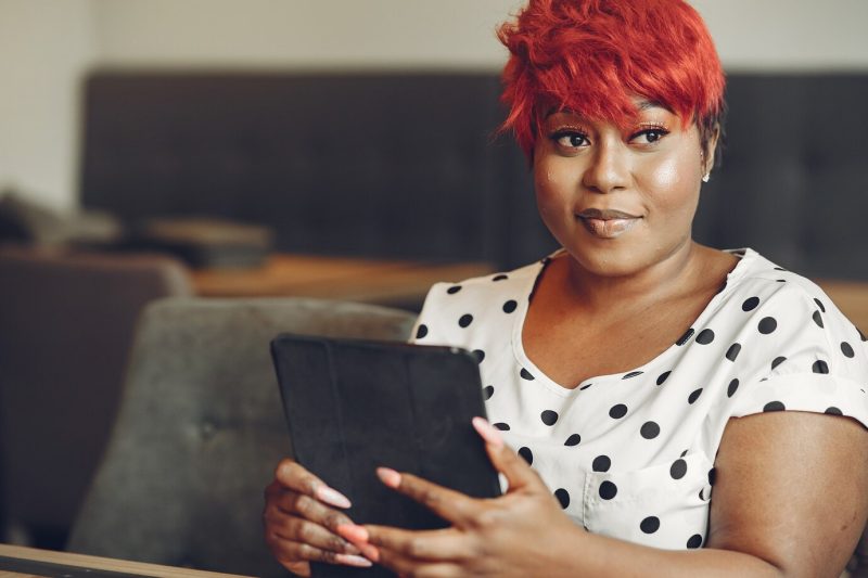 Young african american female working in an office. lady in a white blouse. Free Photo