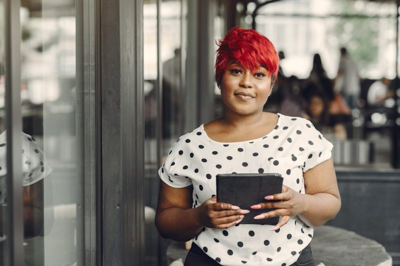 Young African American female working in an office. lady in a white blouse. Free Photo