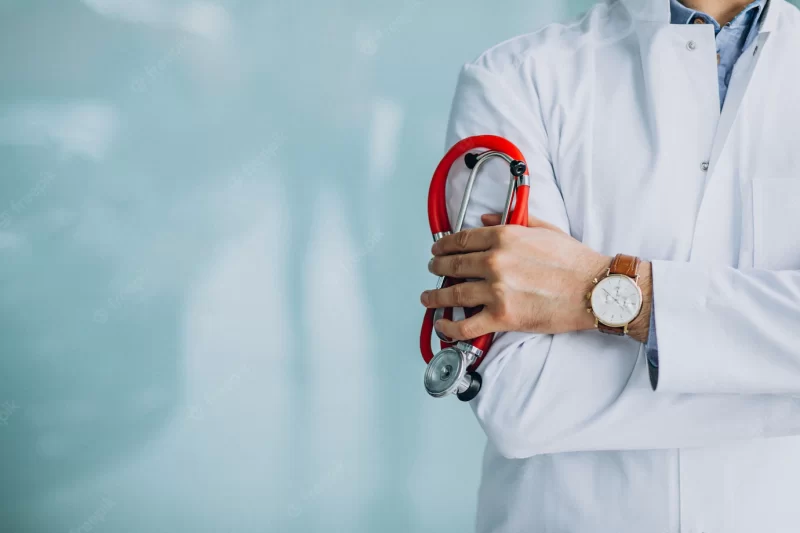 Young handsome physician in a medical robe with stethoscope Free Photo Young handsome physician in a medical robe with stethoscope Free Photo