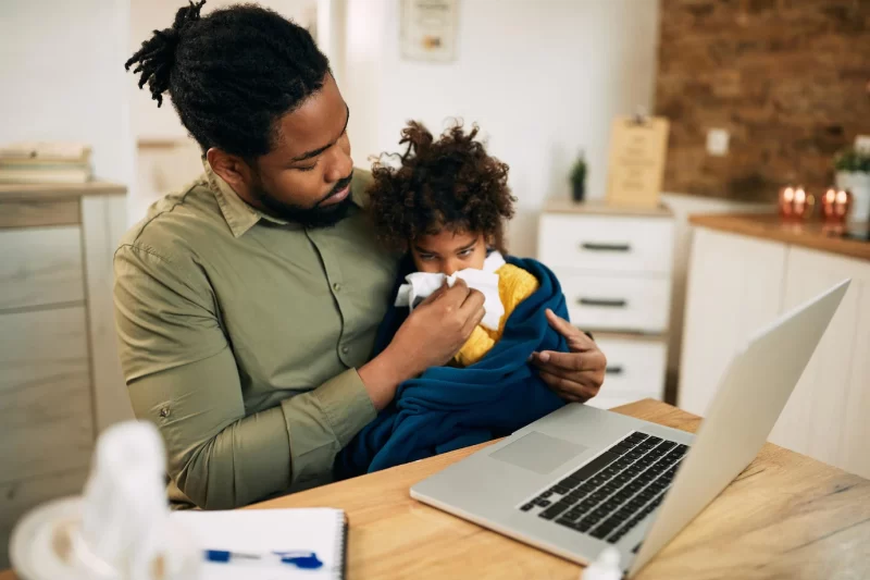 African american father helping daughter to blow her nose at home Free Photo