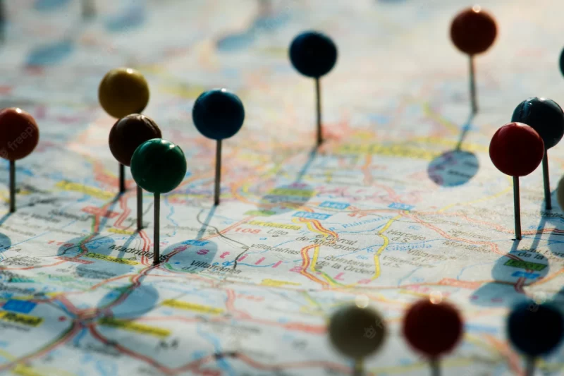 Closeup of pins on the map planning travel journey Free Photo