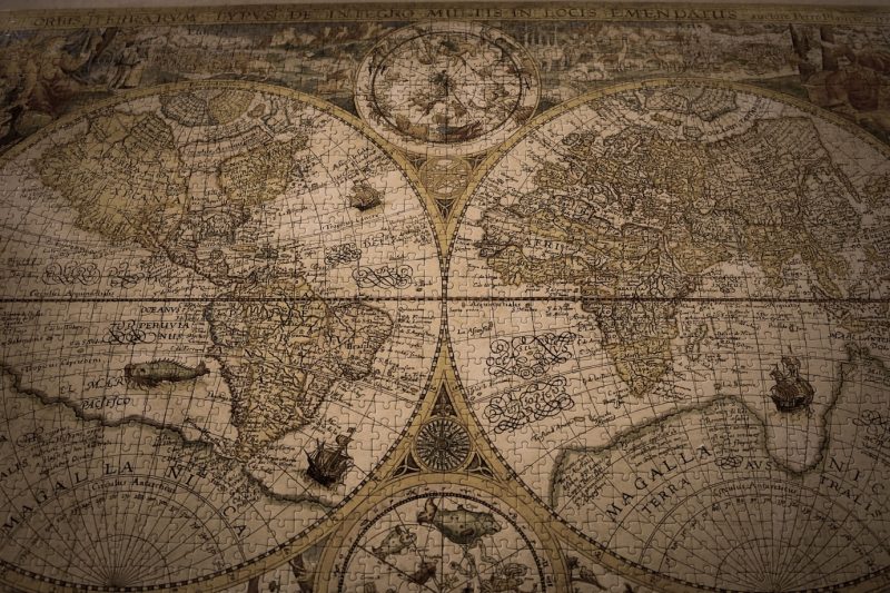 Closeup shot of a vintage world map made with puzzles Free Photo