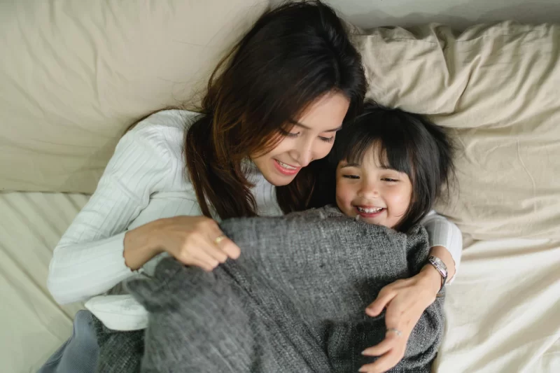 Family happy time with mom and daughter play together on morning bed Free Photo