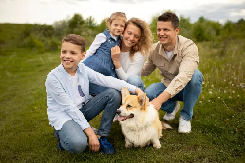 Full shot happy family with cute dog Free Photo