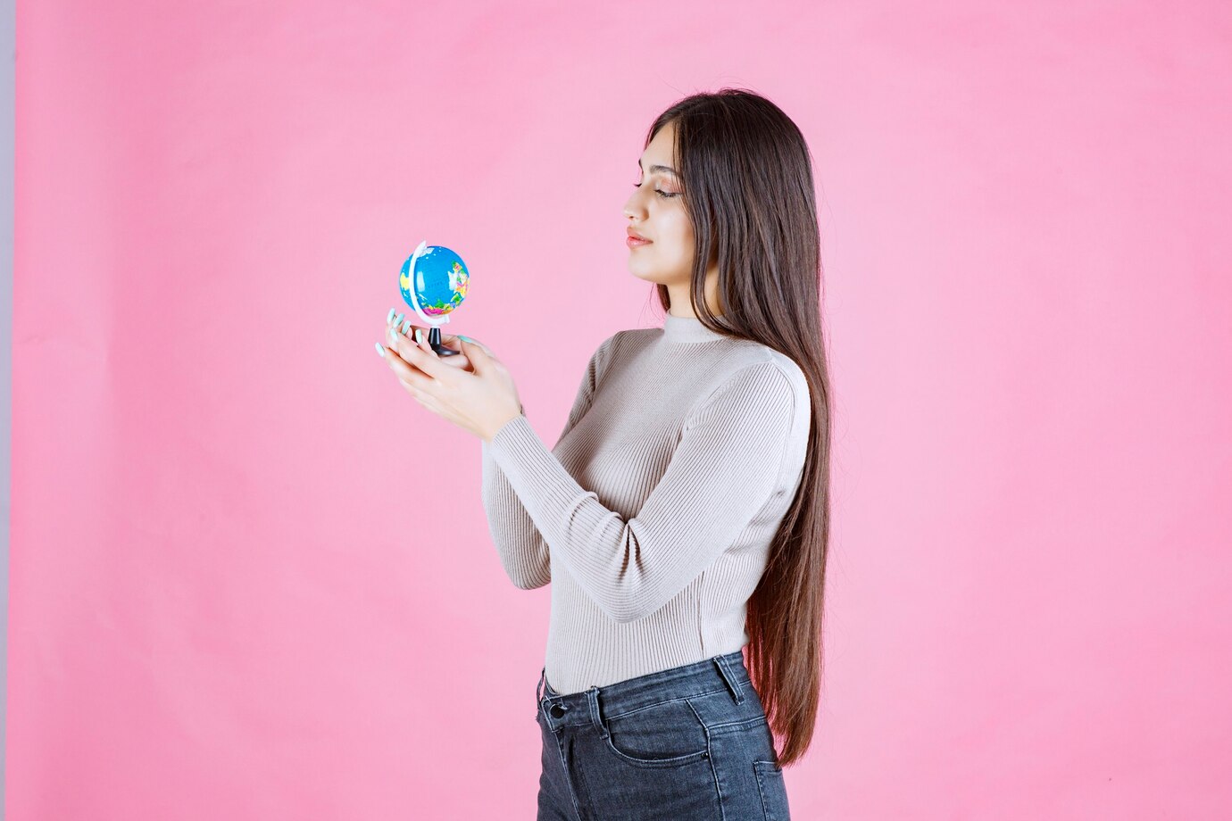 Girl Holding Mini Globe Studying It Attentively 144627 55261