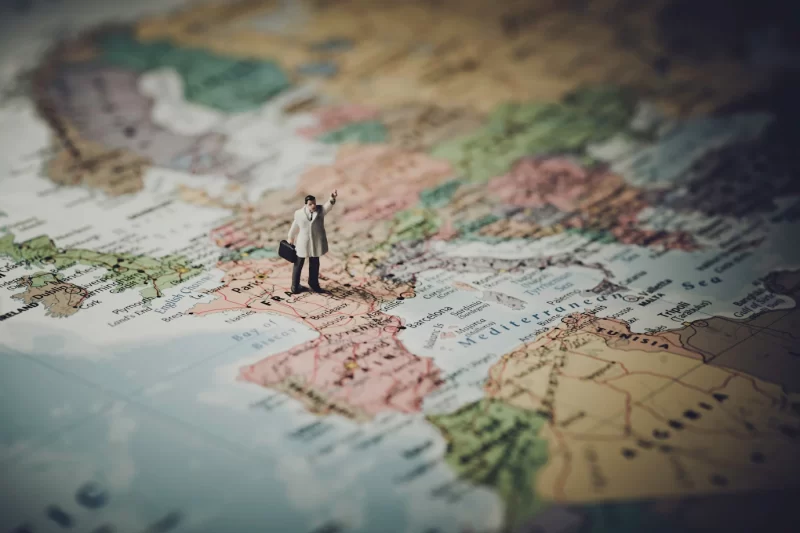 Miniature businessman on map of Europe Free Photo