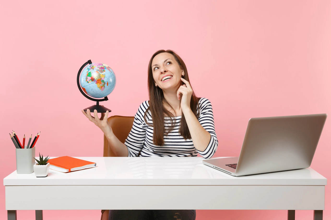 Young Pensive Woman Holding Globe Dreaming Planning Vacation While Sit Work Office With Contemporary Pc Laptop 365776 8072