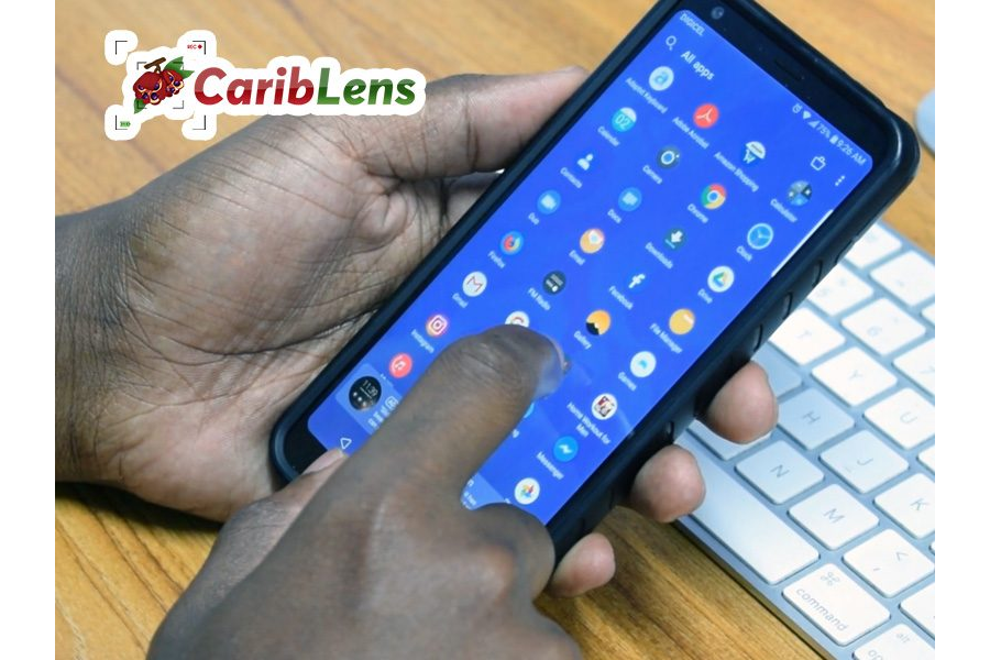 Black hands using mobile phone in front of keyboard