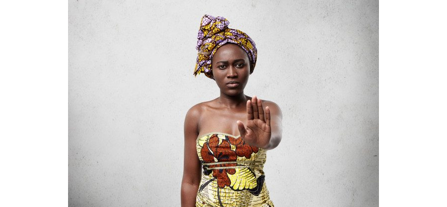 Stop it! African black woman with dark skin wearing traditional clothes showing her palm denying not to do something. confident dark-skinned female showing no gesture. veto and demand concept Free Photo